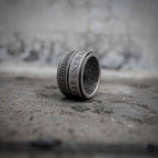 Norse rune spinner ring side view showing dual rotating band with Celtic braid and rune engraving on oxidized stainless steel, Viking dark aesthetic fidget ring by Veilhinge