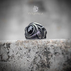 Top-down view of snake ring — twin serpent bodies flanking a domed obsidian stone, scales rendered in oxidized silver, gothic dark aesthetic