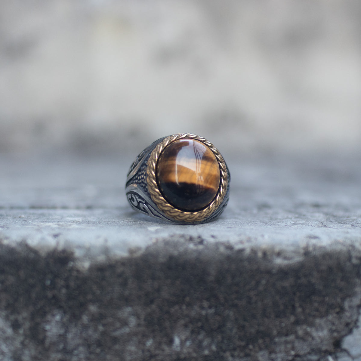 Oversized tiger eye signet ring with a gold-tone rope bezel, front view