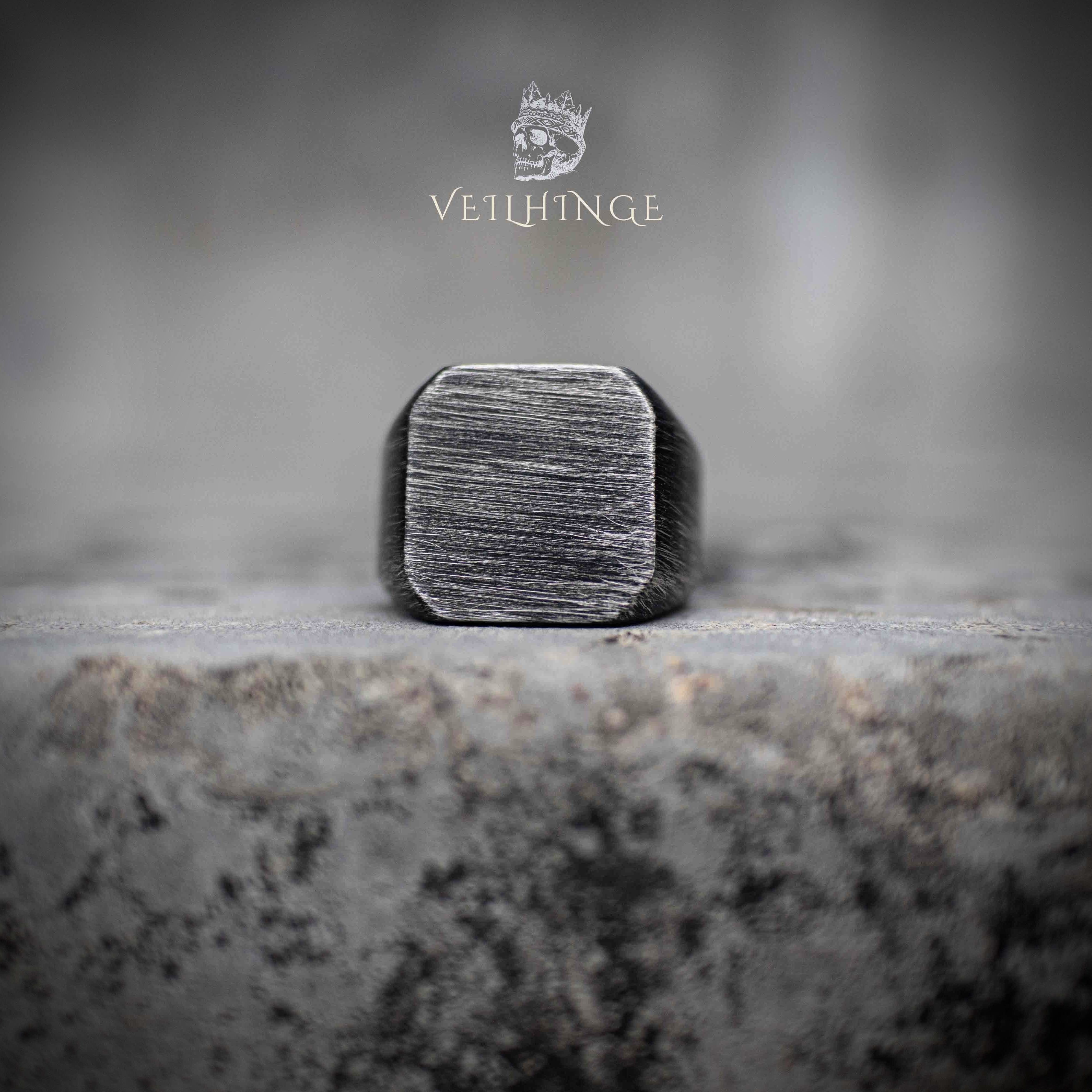 oxidized square signet ring with horizontal brushed texture — front view on concrete surface Main image