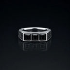 Rune Triple-Stone Signet Ring with three square black onyx stones on a reflective black background