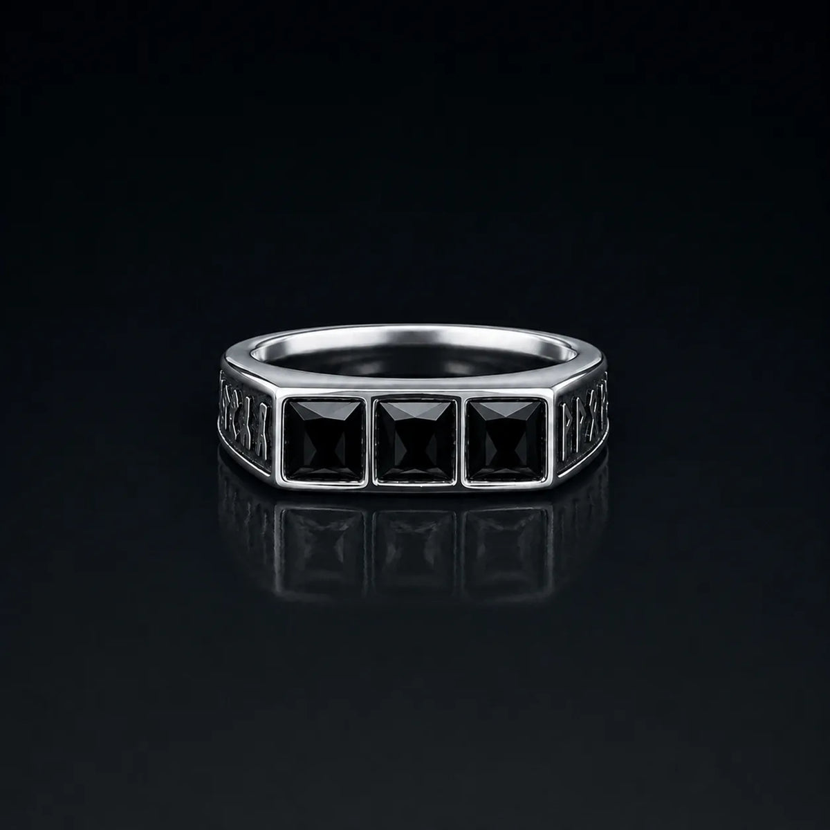 Rune Triple-Stone Signet Ring with three square black onyx stones on a reflective black background
