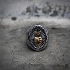 Sacred Heart of Jesus oval signet ring with gold embossed sacred heart and cross, stainless steel two-tone religious gothic ring by Veilhinge, front view