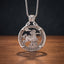 sagittarius centaur coin pendant necklace — centaur archer hand-cut on coin face with alchemical symbol border, flames at base, four-prong open frame, skull bail, antique silver tone, dark wood surface