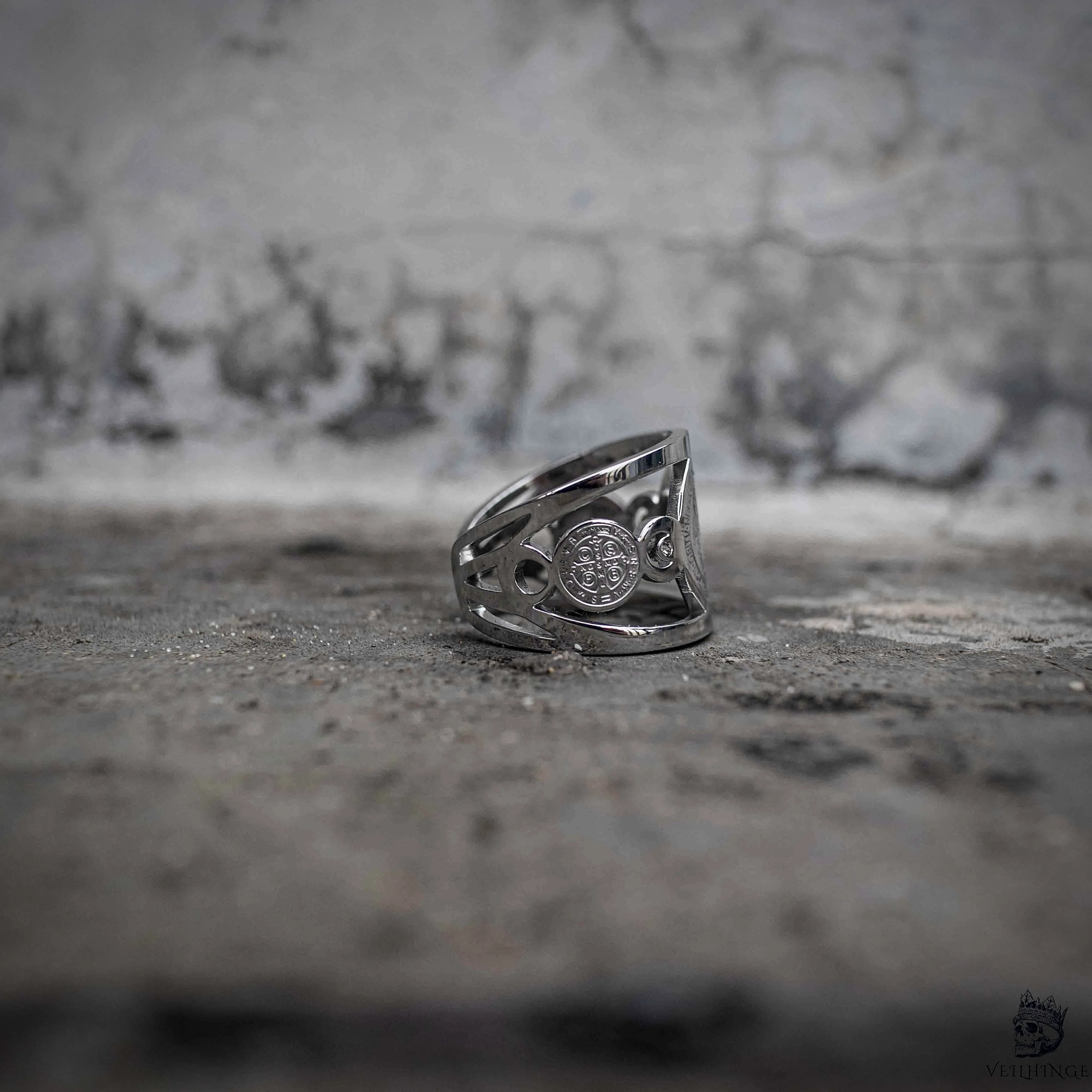 Saint Benedict medal ring side view showing openwork band and reverse medallion engraving, dark aesthetic stainless steel jewelry by Veilhinge