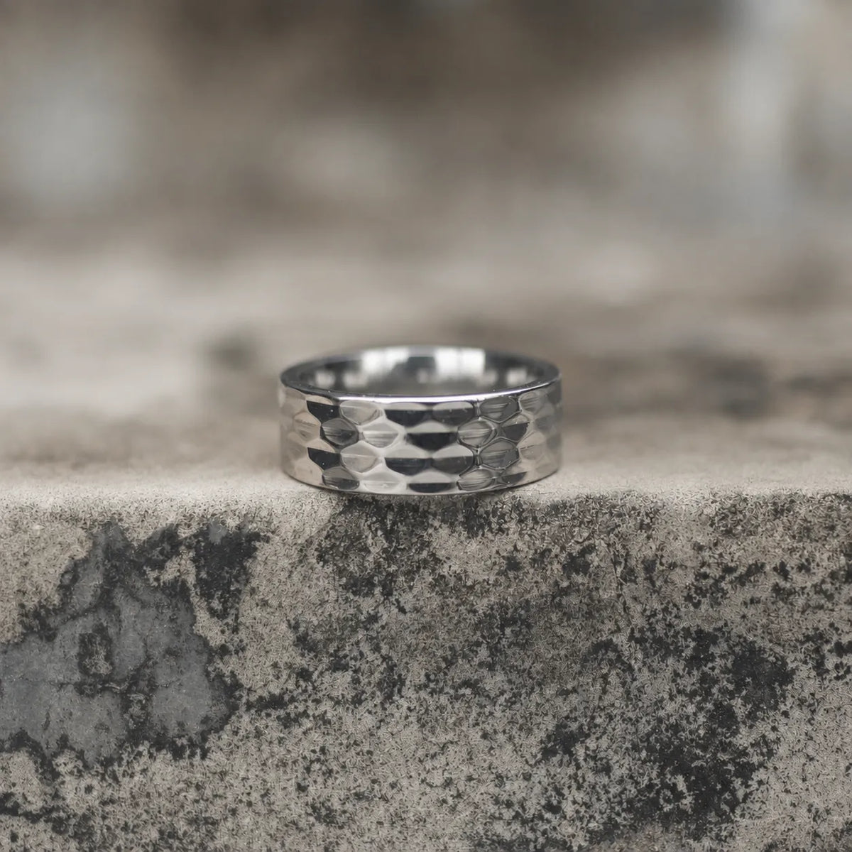 Silver-tone wide band ring with a repeating geometric faceted pattern Main image