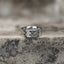 Silver-tone wide band ring with a repeating geometric faceted pattern