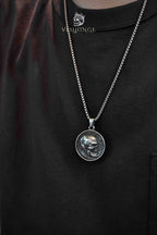 Skull coin pendant necklace worn close-up on chest, gothic skull medallion necklace, dark aesthetic alternative jewelry
