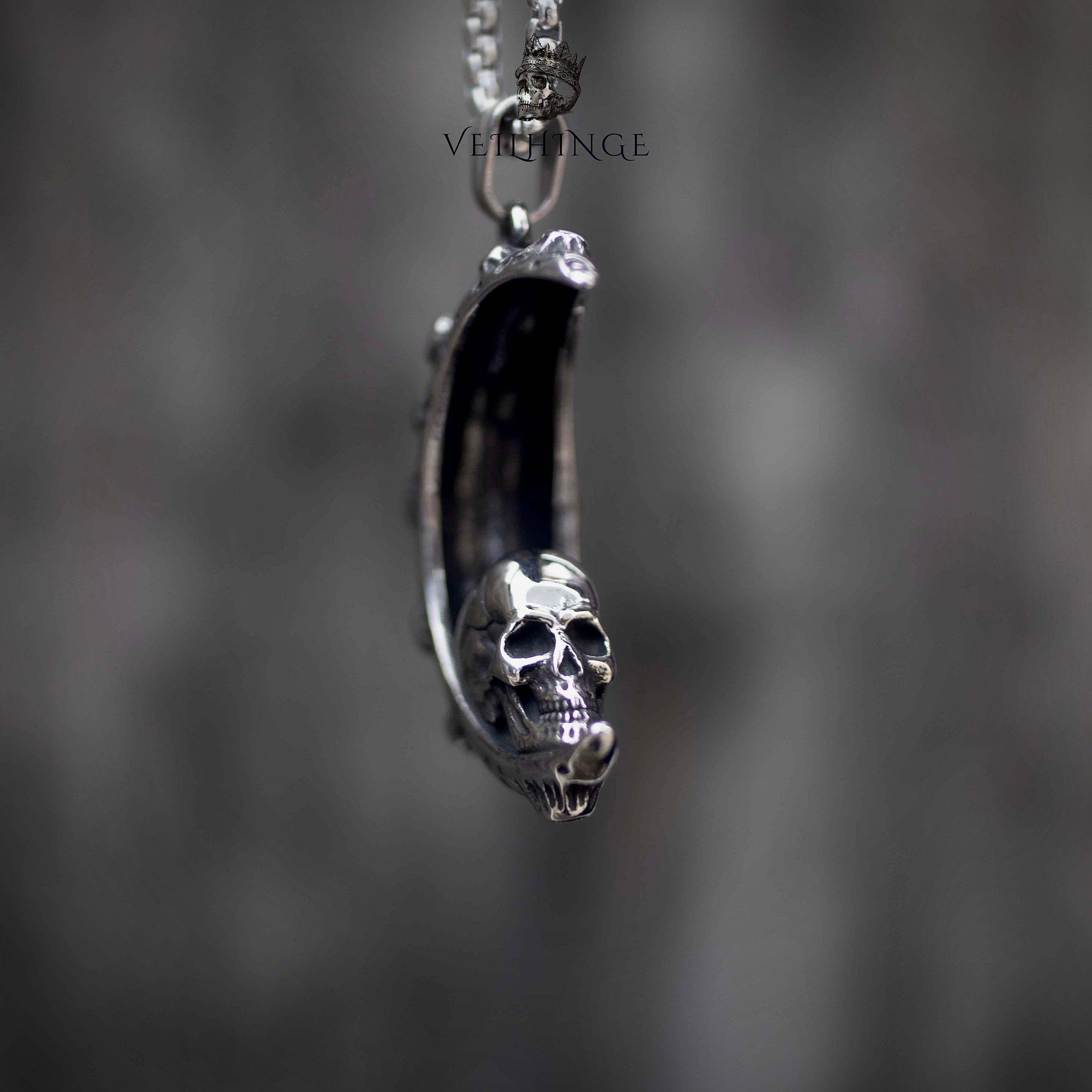 Skull crescent moon pendant necklace side view, three-dimensional skull emerging from crescent moon, oxidized silver, dark aesthetic gothic jewelry