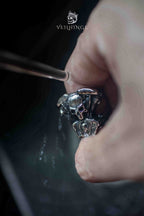 Live to Ride skull ring held under running water, showing the ring's tarnish-resistant oxidized finish