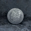 Close-up of a coin engraved with a skull-faced Lady Liberty, flowing curly hair, wheat and floral crown, striped shield below, E Pluribus Unum border, dated 1887