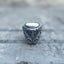Oval mirror face and skull detailing on the silver-tone signet ring