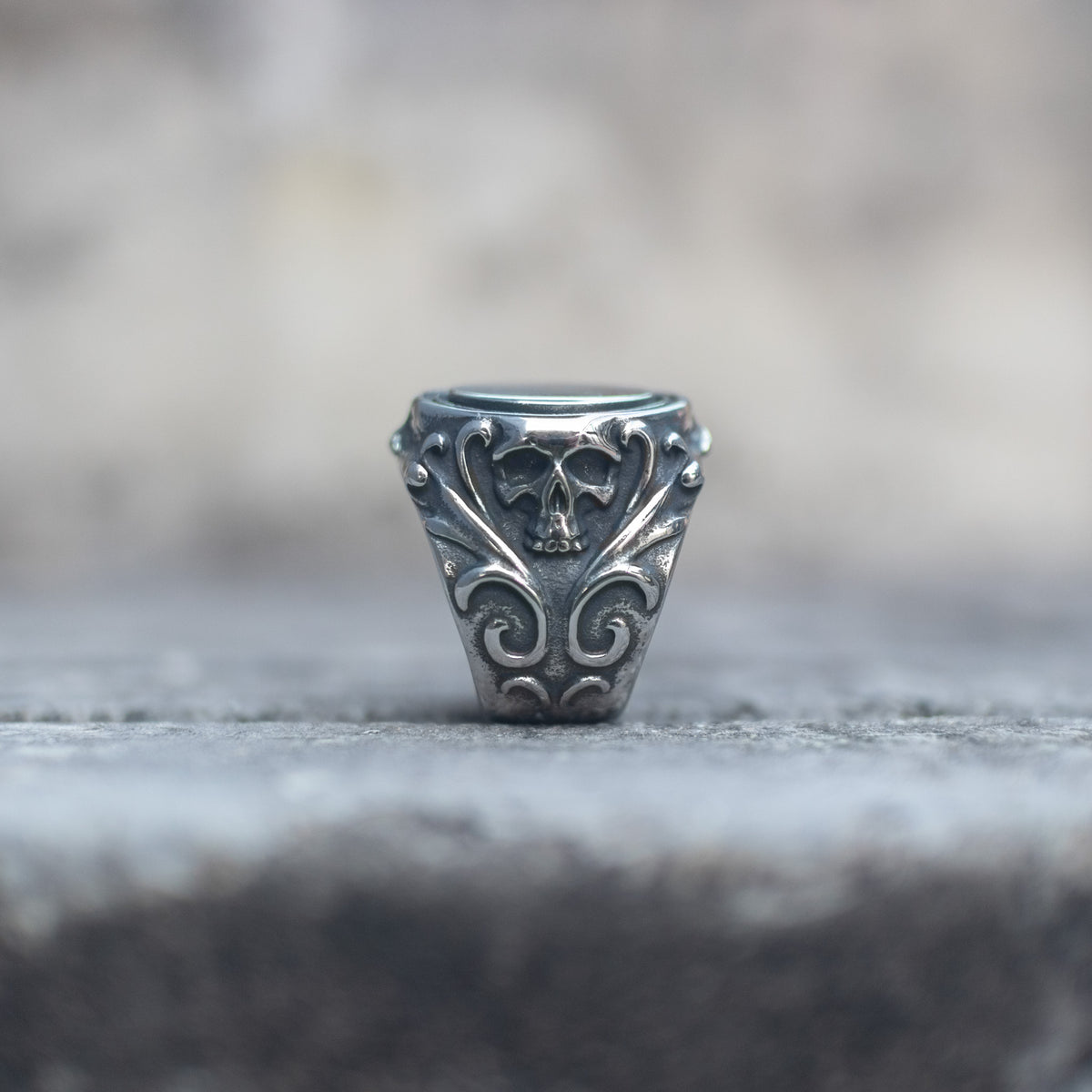 Skull and scrollwork details on the side of the mirror signet ring