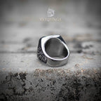 Side profile of skull and tentacle signet ring showing tapered band construction and smooth polished inner surface — substantial gothic ring on stone