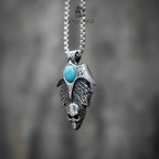 Skull wing pendant necklace front view, turquoise stone with spread wings and skull detail, oxidized silver, gothic statement necklace
