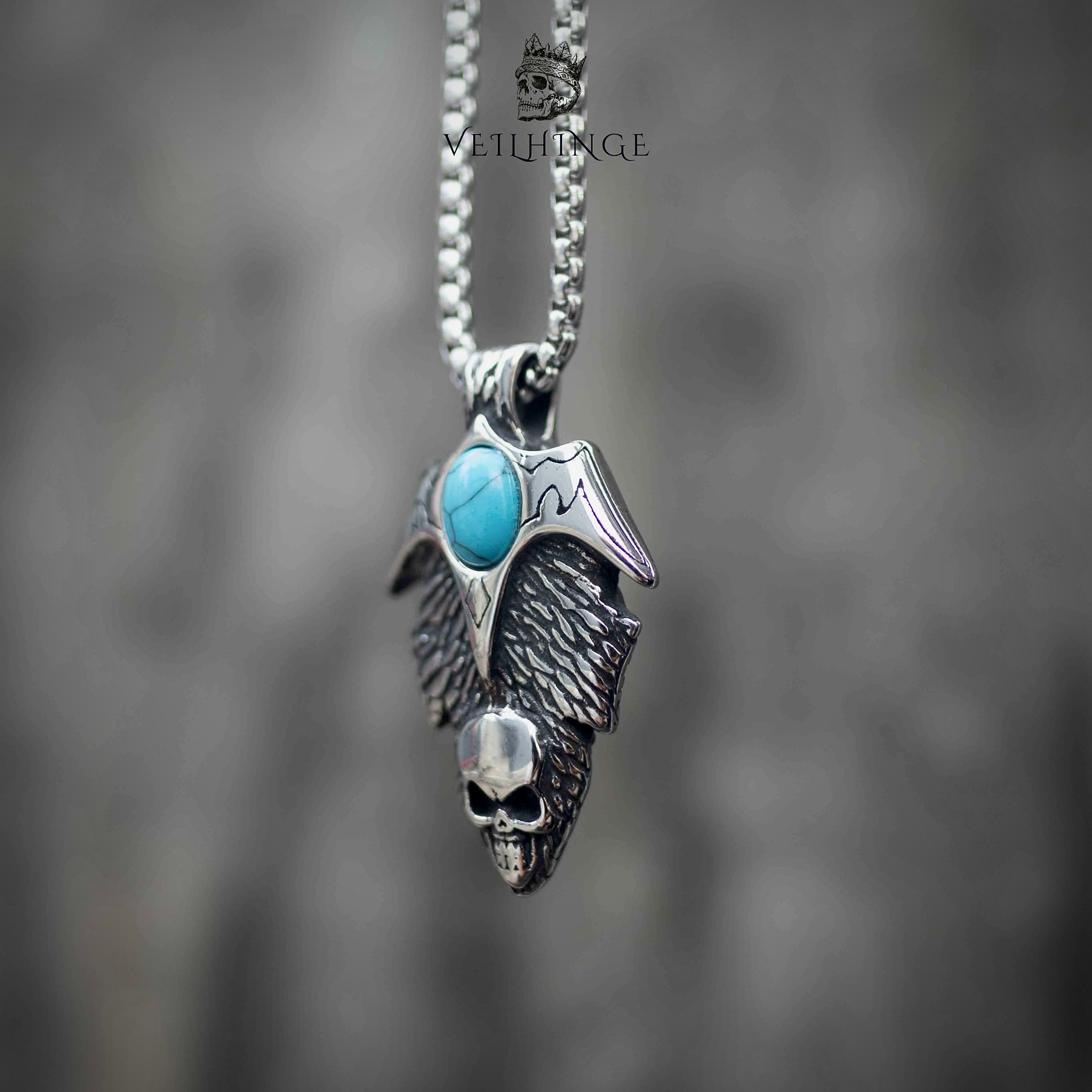 Skull wing pendant necklace front view, turquoise stone with spread wings and skull detail, oxidized silver, gothic statement necklace