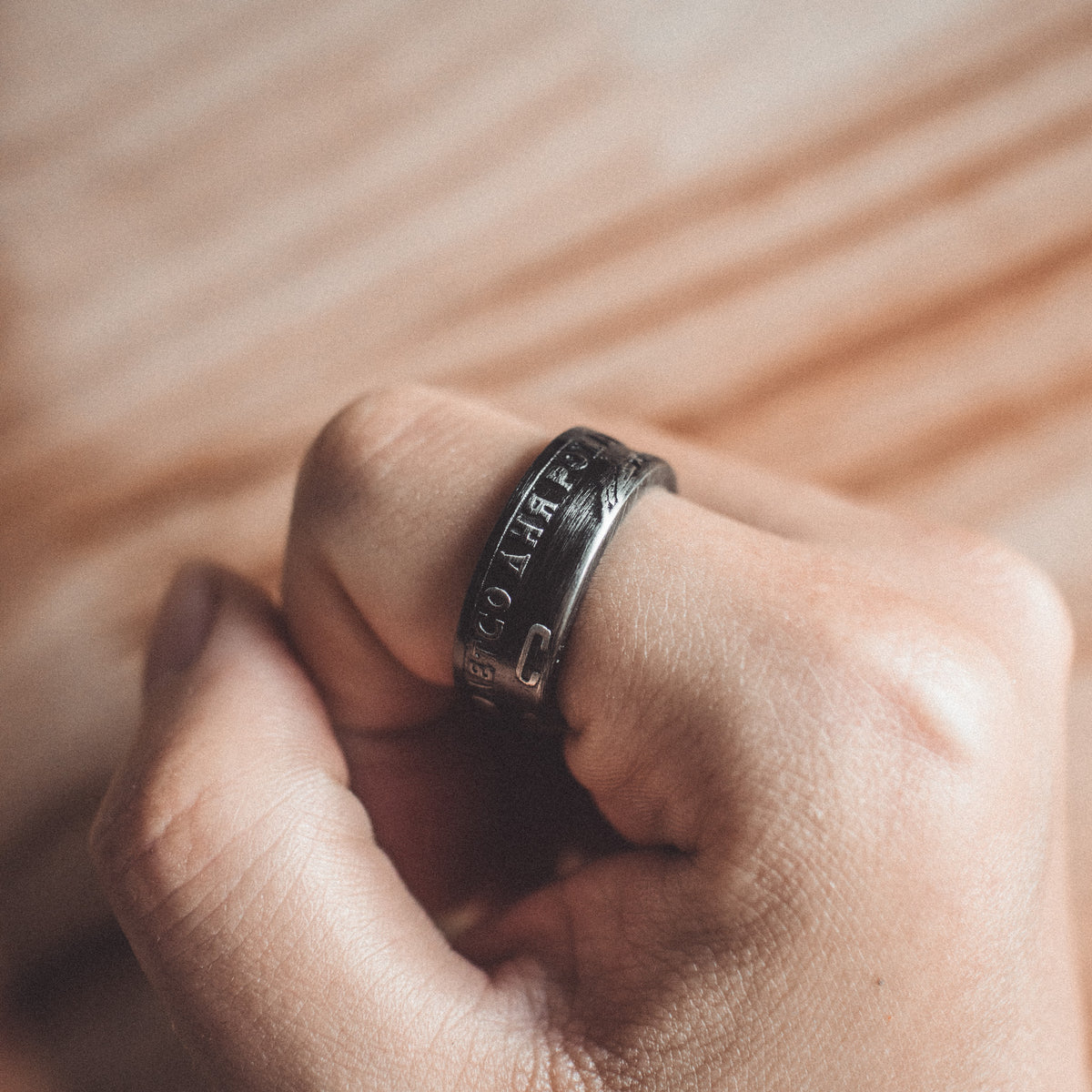 Close-up of the VEILHINGE Soviet Coin Ring worn on hand, featuring the Lenin Centenary commemorative band design.