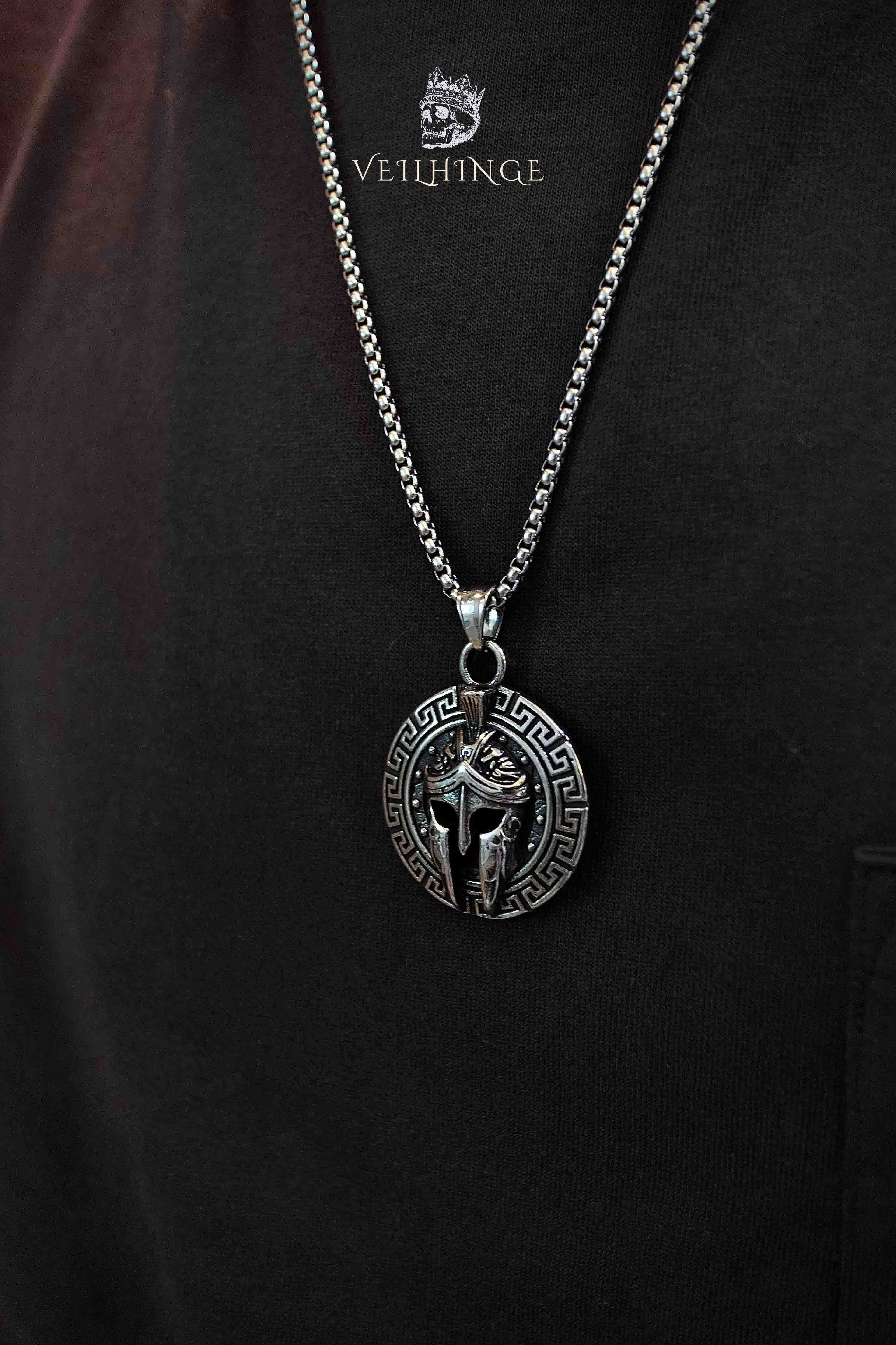 Spartan helmet pendant necklace worn on model, Greek key border coin pendant, oxidized silver, dark aesthetic medieval jewelry