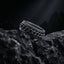 stainless steel chain spinner ring rotating band detail place on dark rock