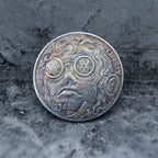 Close-up of a coin engraved with a steampunk character in mechanical round goggles with gear patterns, flowing curly hair, rivet dot details below, Liberty inscription, dated 1934