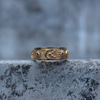 Gold-tone spinner ring with raised sun, crescent moon and star details, front view