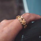 Gold-tone sun, moon and stars spinner ring worn on the finger