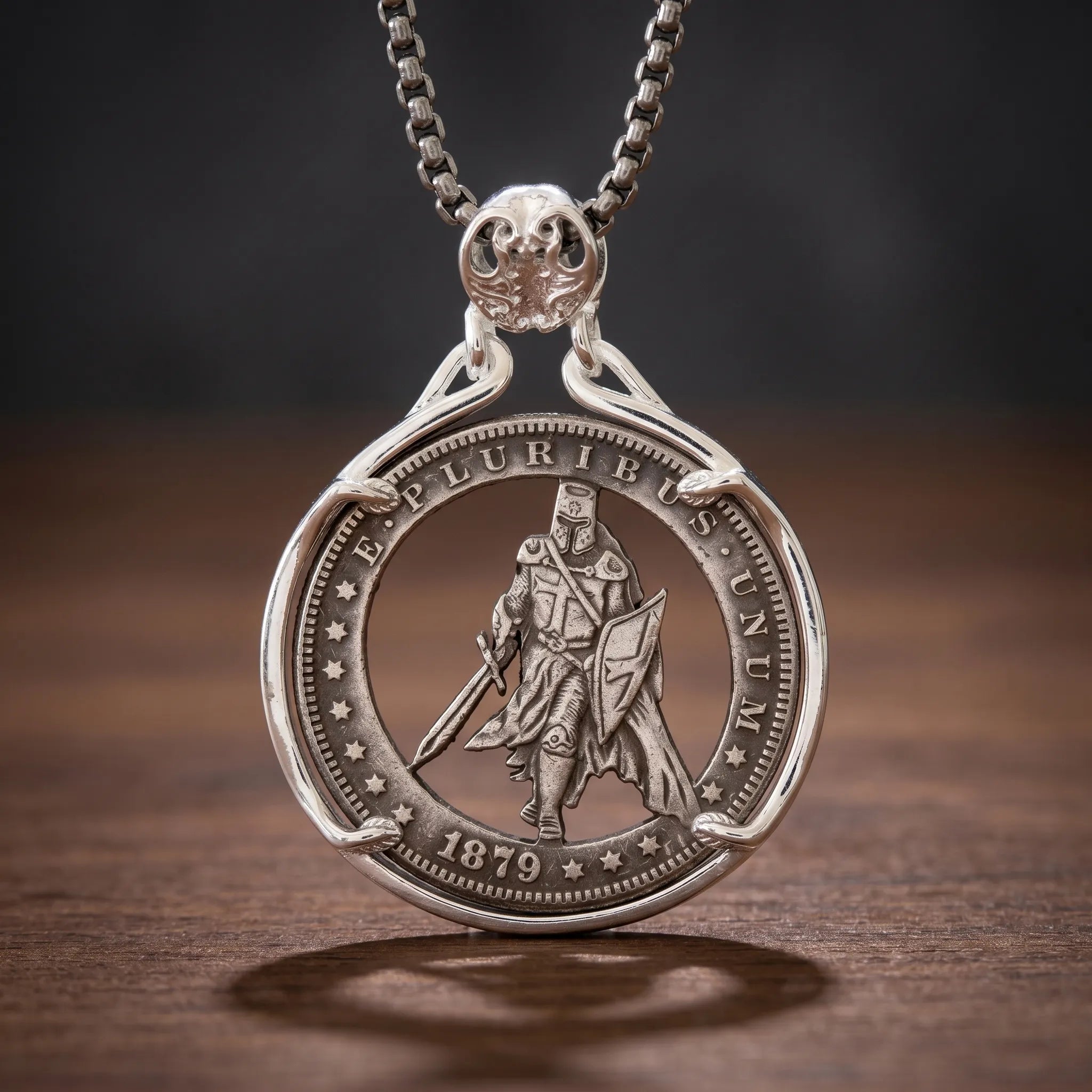 templar knight hobo coin pendant necklace — armored crusader with sword and shield hand-cut on 1879 coin face, E pluribus unum inscription, four-prong open frame, skull bail, antique silver tone, dark wood surface