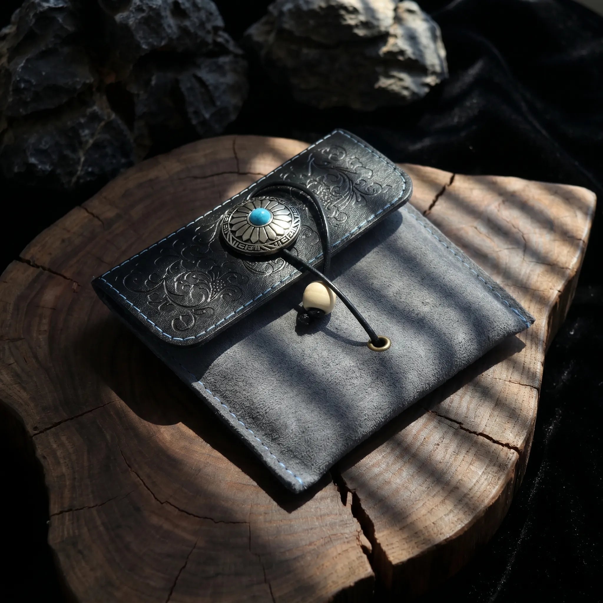 Veilhinge embossed leather jewelry pouch with antique silver concho button closure on wooden surface Main image