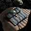 Veilhinge embossed leather jewelry pouch with antique silver concho button closure on wooden surface