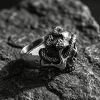 gothic skull ring with snake design metal texture close up