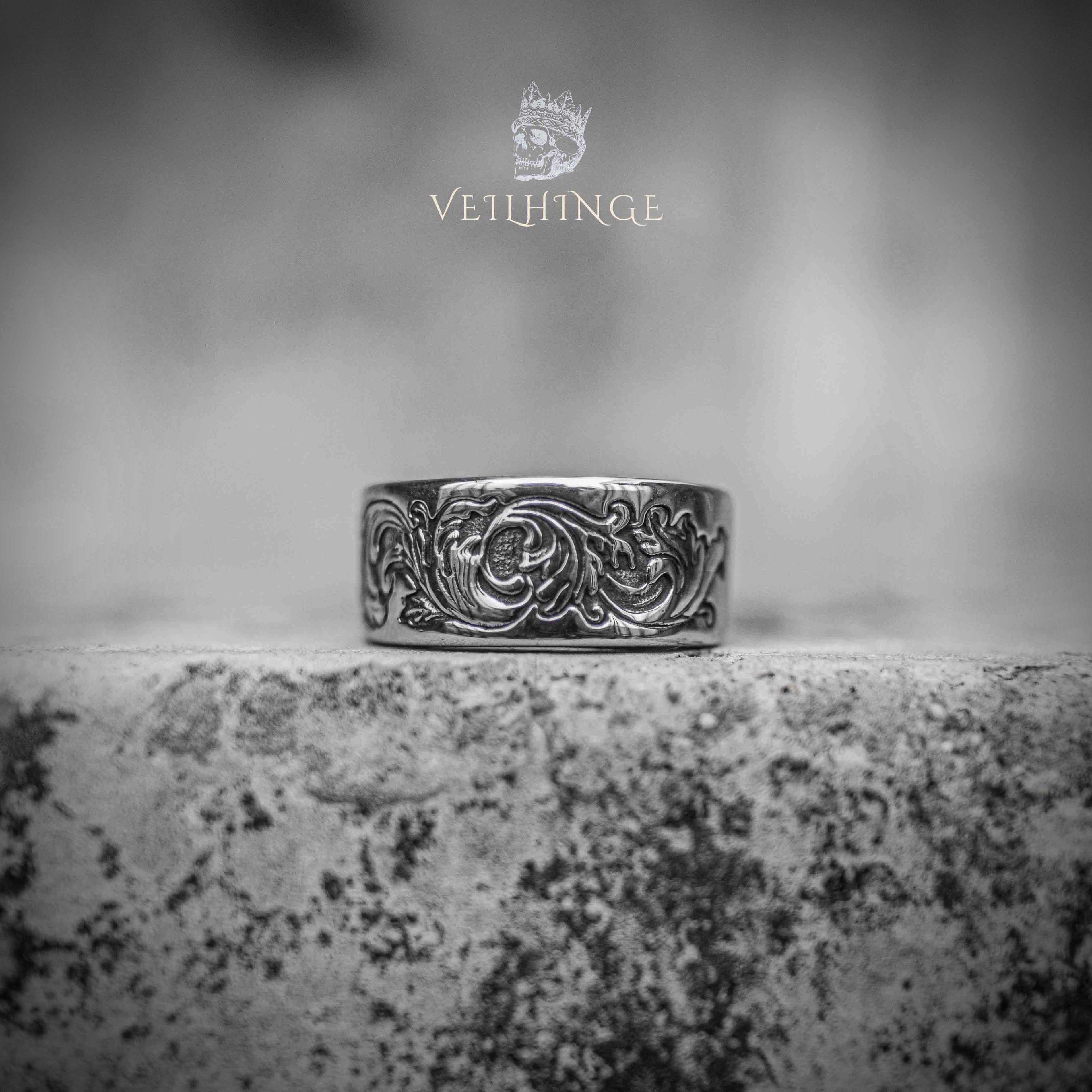 Wide band ring with continuous Victorian floral scroll engraving — oxidized silver finish, acanthus leaf pattern wrapping the full band Main image