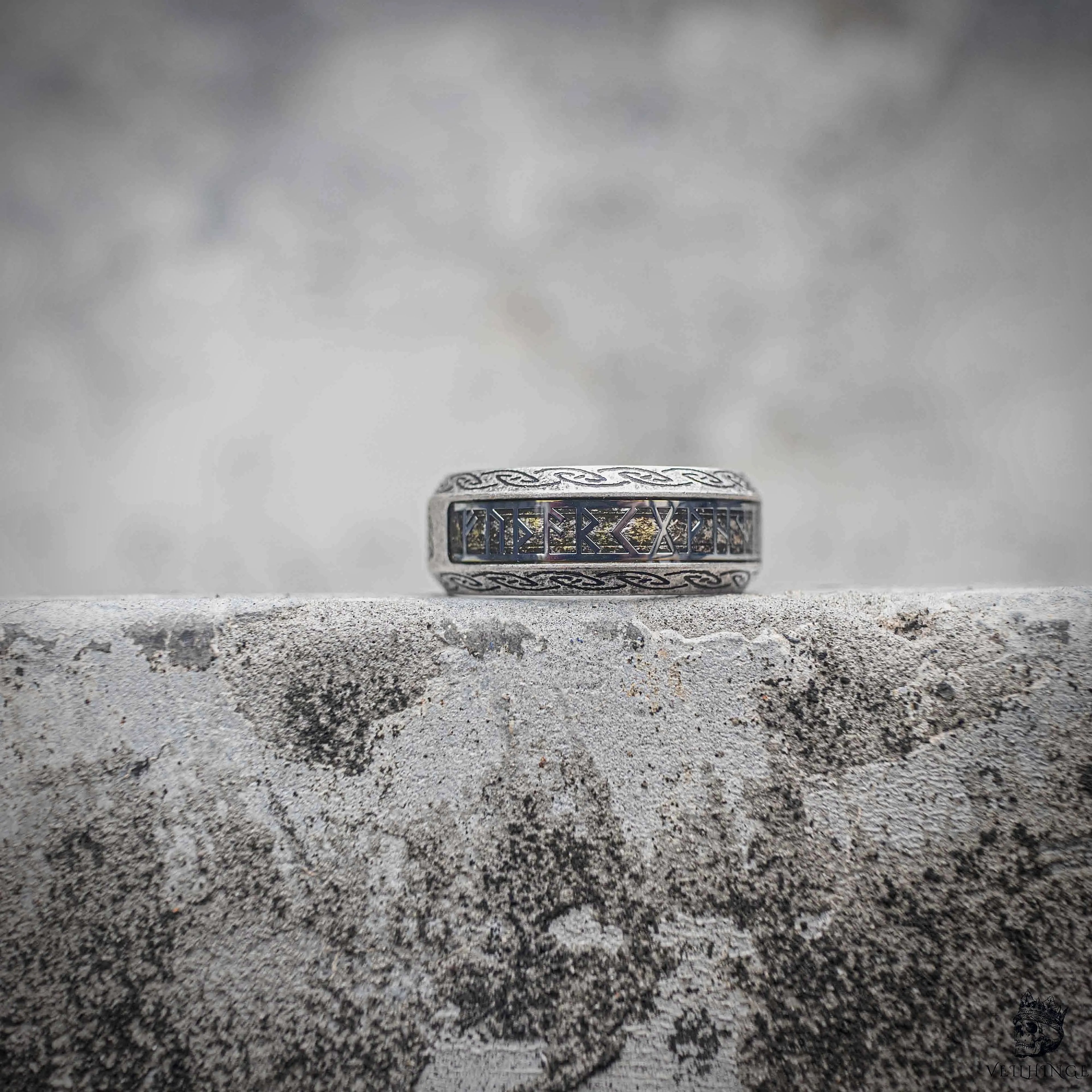 Viking rune band ring with Elder Futhark rune sequence engraving on sandblasted silver stainless steel, Norse medieval dark aesthetic ring by Veilhinge, angled view