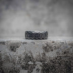 Viking rune ring with snake scale diamond lattice texture and Elder Futhark rune band in oxidized black stainless steel, dark aesthetic Norse ring by Veilhinge, front view