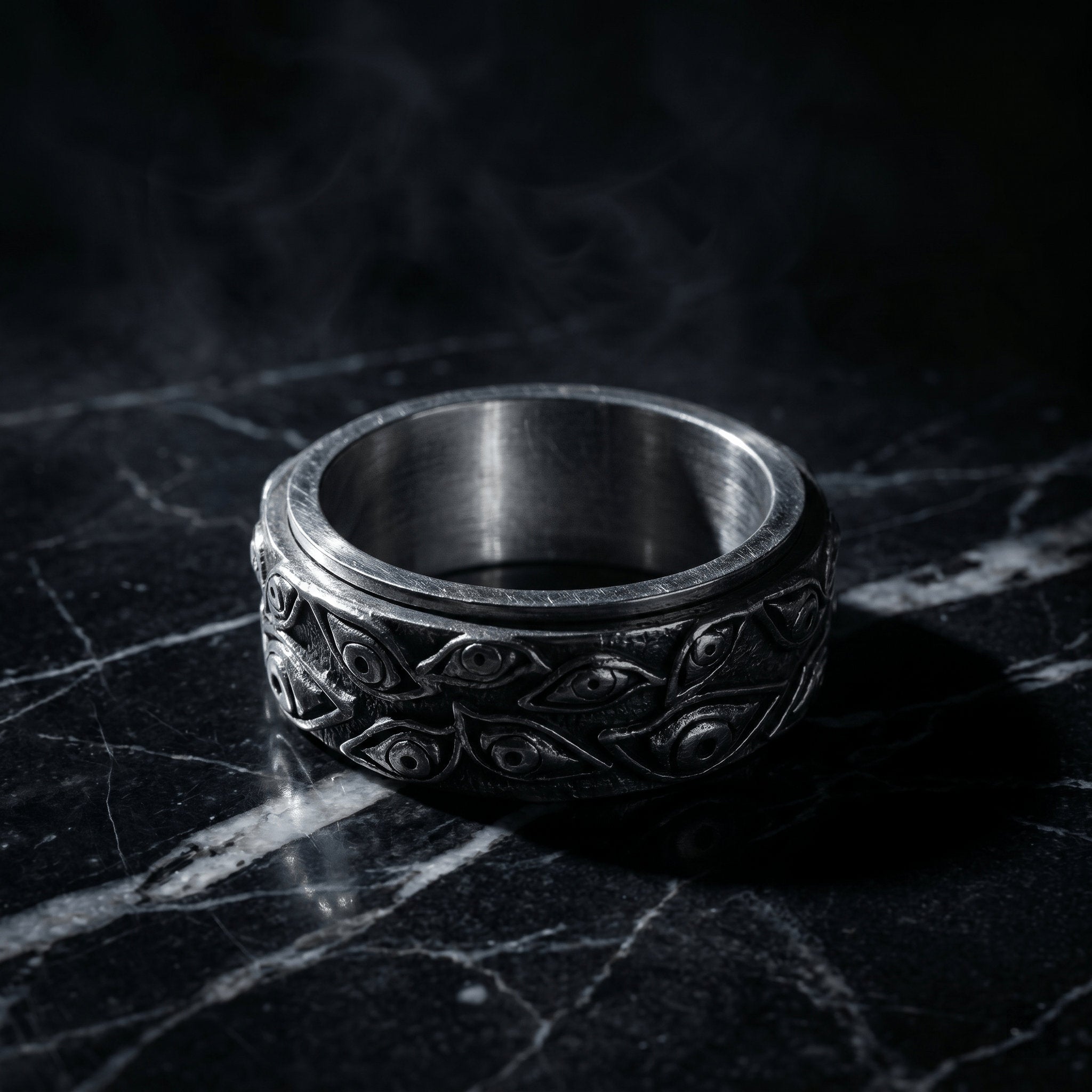 stainless steel spinner ring with engraved evil eye pattern