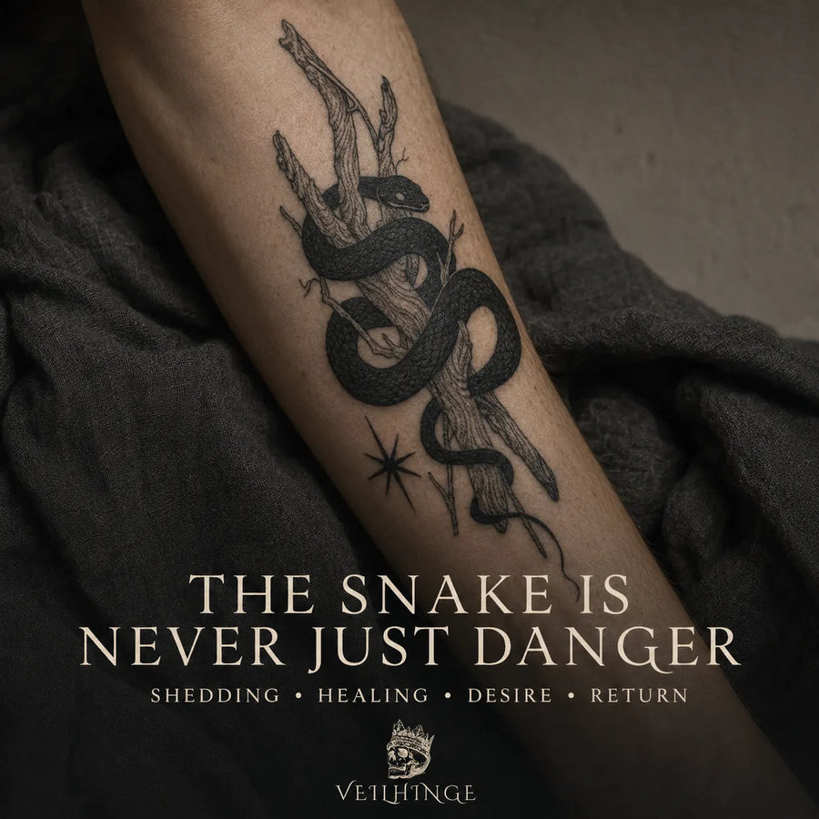 Black snake tattoo coiled around weathered branches on a forearm, symbolizing shedding, healing, desire and return.