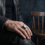 gothic white stone signet ring worn with leather jacket