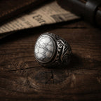 vintage engraved white stone ring on wooden surface